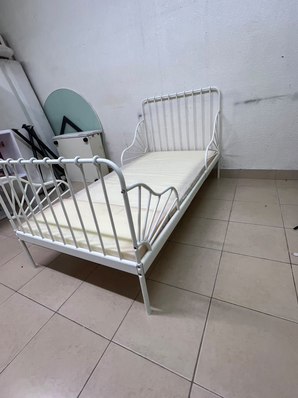 The white extendable metal bed frame "MINNEN" from IKEA, featuring side rails with distinctive scrollwork details. - Image 6
