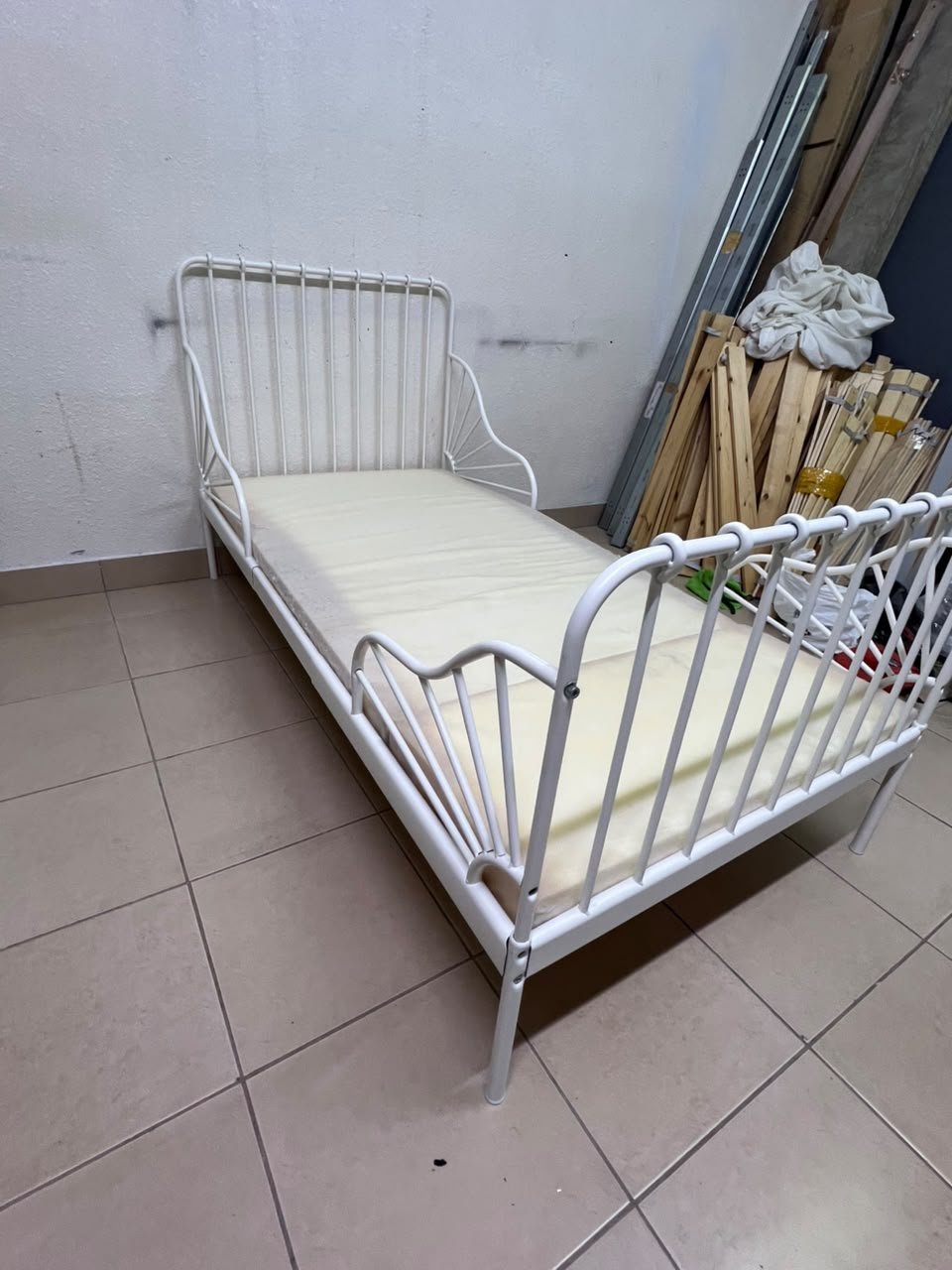 The white extendable metal bed frame "MINNEN" from IKEA, featuring side rails with distinctive scrollwork details. - Image 7