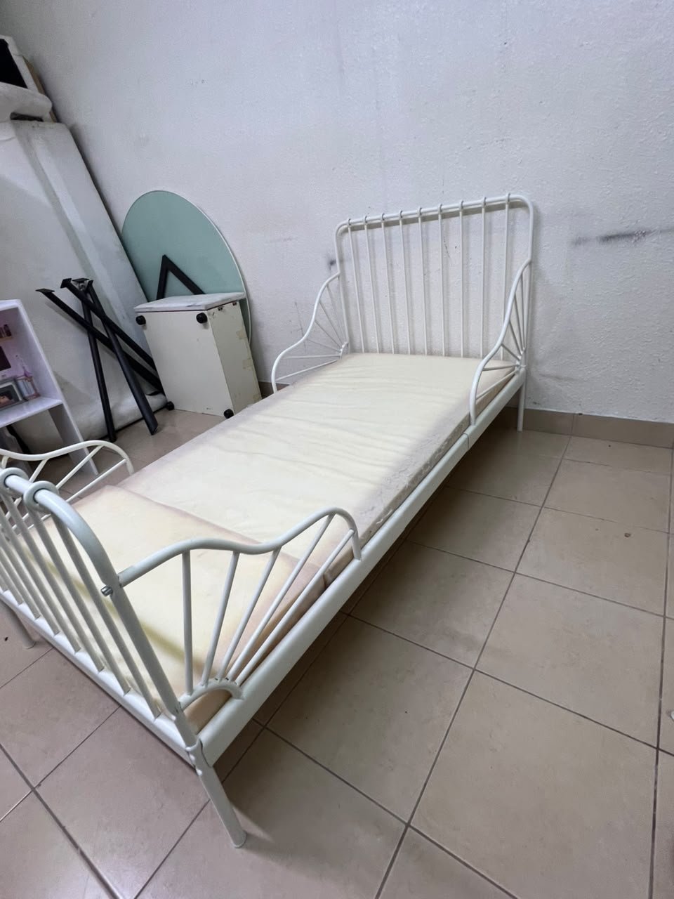 The white extendable metal bed frame "MINNEN" from IKEA, featuring side rails with distinctive scrollwork details. - Image 8