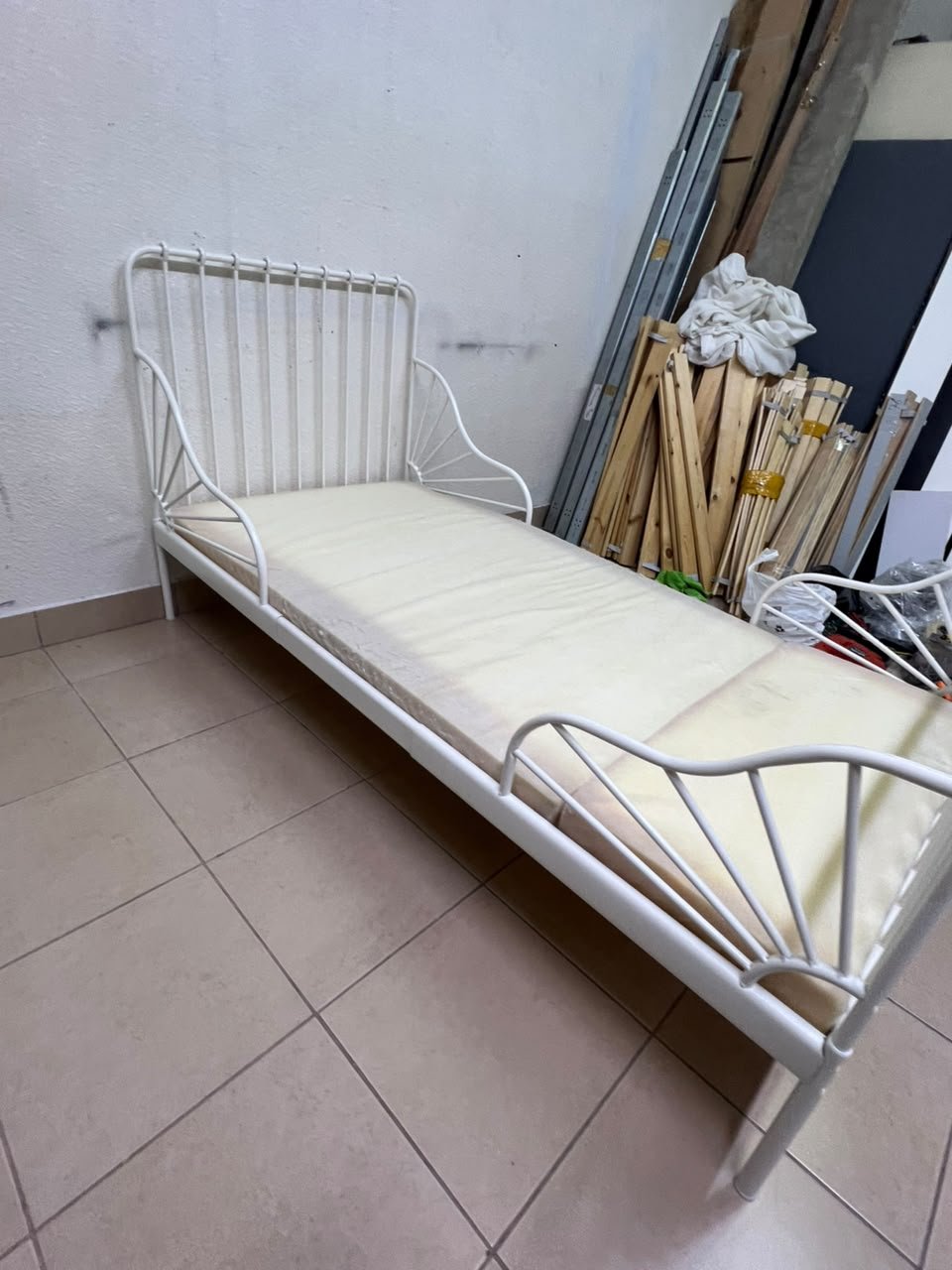 The white extendable metal bed frame "MINNEN" from IKEA, featuring side rails with distinctive scrollwork details. - Image 10
