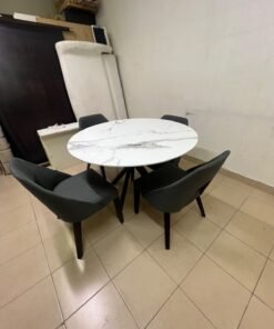 This modern dining set features a round table with a white marble-effect top, paired with curved, arm-equipped chairs upholstered in dark gray and supported by black metal legs. - Image 8