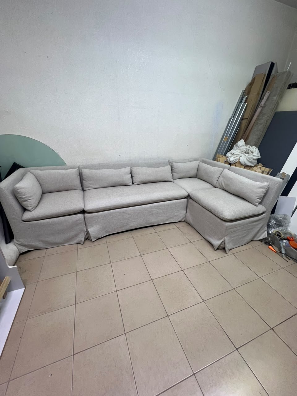 The L-shaped sectional sofa features a removable cover; it is the Crate & Barrel Belmar Modular Seating model, upholstered in a light gray, high-performance fabric with a linen-like texture, and includes comfortable back and arm cushions. - Image 2