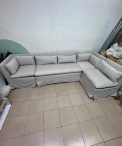 The L-shaped sectional sofa features a removable cover; it is the Crate & Barrel Belmar Modular Seating model, upholstered in a light gray, high-performance fabric with a linen-like texture, and includes comfortable back and arm cushions. - Image 4