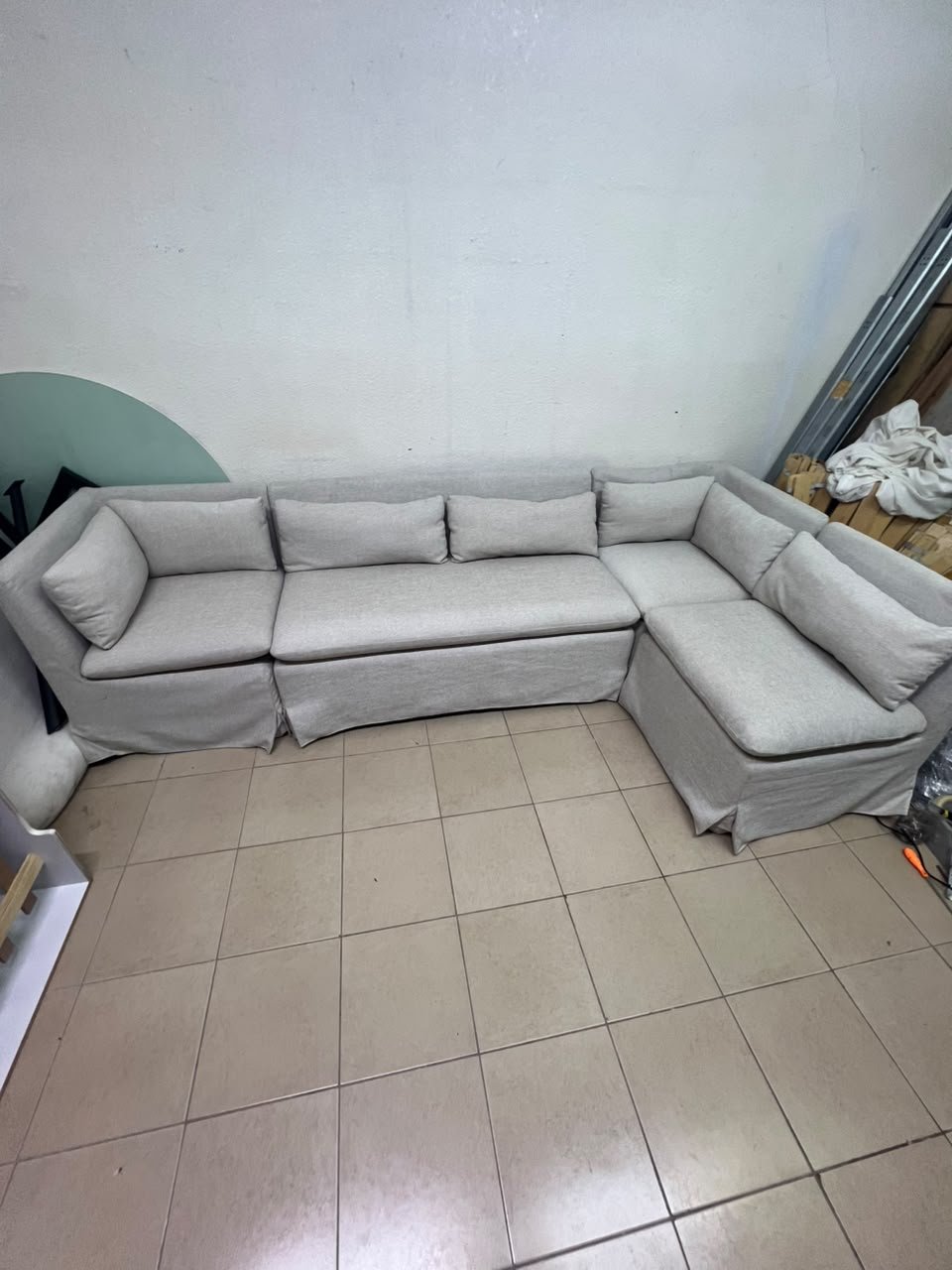The L-shaped sectional sofa features a removable cover; it is the Crate & Barrel Belmar Modular Seating model, upholstered in a light gray, high-performance fabric with a linen-like texture, and includes comfortable back and arm cushions. - Image 4