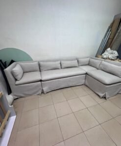 The L-shaped sectional sofa features a removable cover; it is the Crate & Barrel Belmar Modular Seating model, upholstered in a light gray, high-performance fabric with a linen-like texture, and includes comfortable back and arm cushions. - Image 5