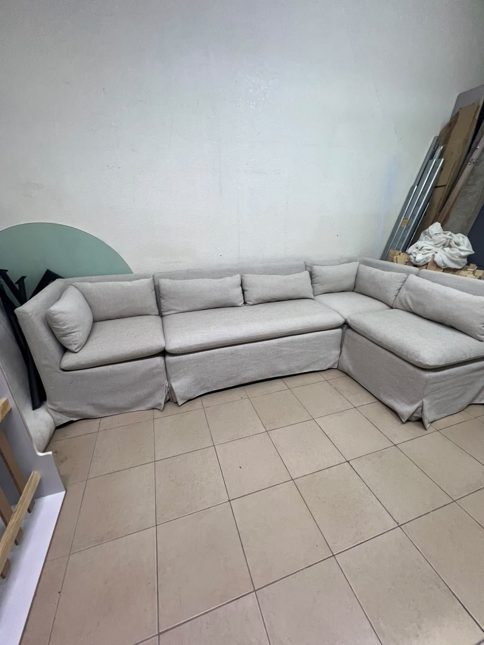 The L-shaped sectional sofa features a removable cover; it is the Crate & Barrel Belmar Modular Seating model, upholstered in a light gray, high-performance fabric with a linen-like texture, and includes comfortable back and arm cushions. - Image 5