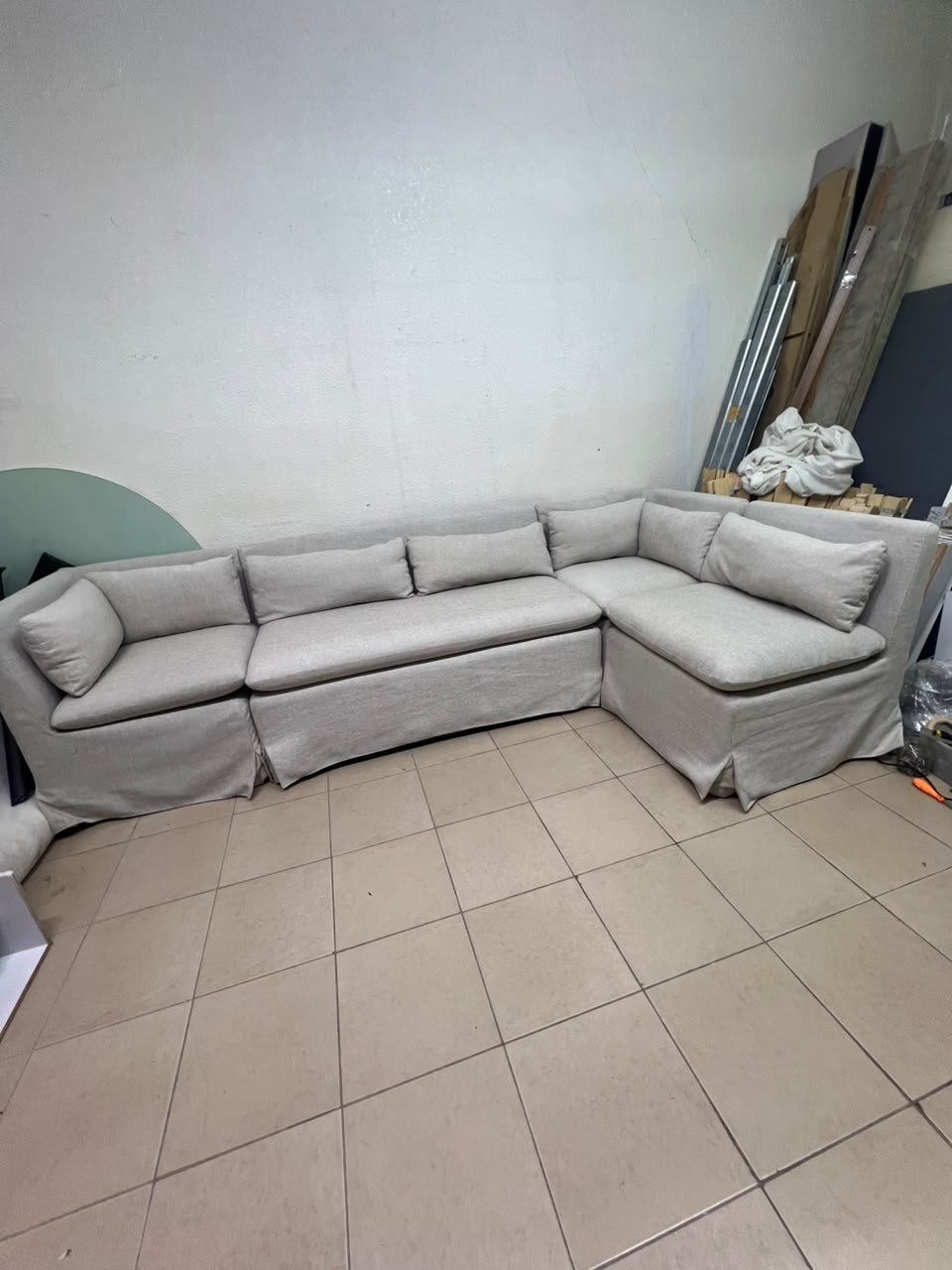 The L-shaped sectional sofa features a removable cover; it is the Crate & Barrel Belmar Modular Seating model, upholstered in a light gray, high-performance fabric with a linen-like texture, and includes comfortable back and arm cushions. - Image 9