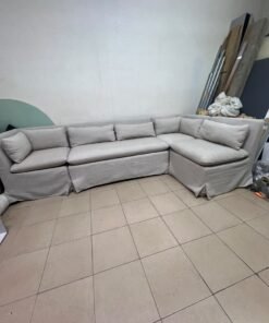 The L-shaped sectional sofa features a removable cover; it is the Crate & Barrel Belmar Modular Seating model, upholstered in a light gray, high-performance fabric with a linen-like texture, and includes comfortable back and arm cushions. - Image 8
