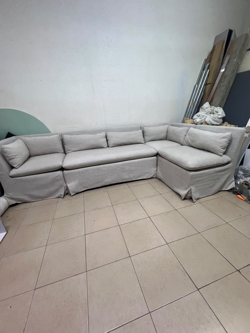 The L-shaped sectional sofa features a removable cover; it is the Crate & Barrel Belmar Modular Seating model, upholstered in a light gray, high-performance fabric with a linen-like texture, and includes comfortable back and arm cushions. - Image 8