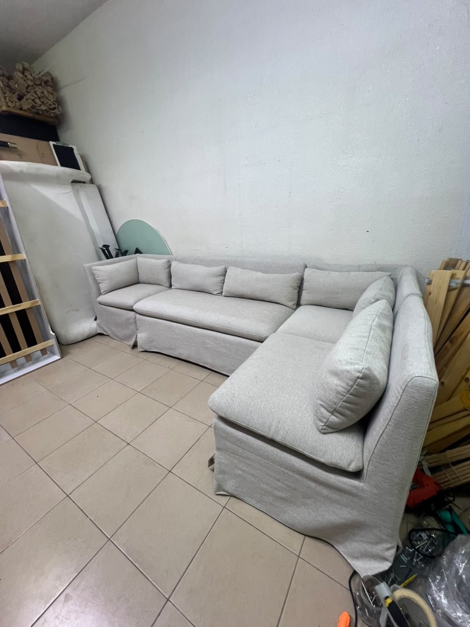 The L-shaped sectional sofa features a removable cover; it is the Crate & Barrel Belmar Modular Seating model, upholstered in a light gray, high-performance fabric with a linen-like texture, and includes comfortable back and arm cushions. - Image 10