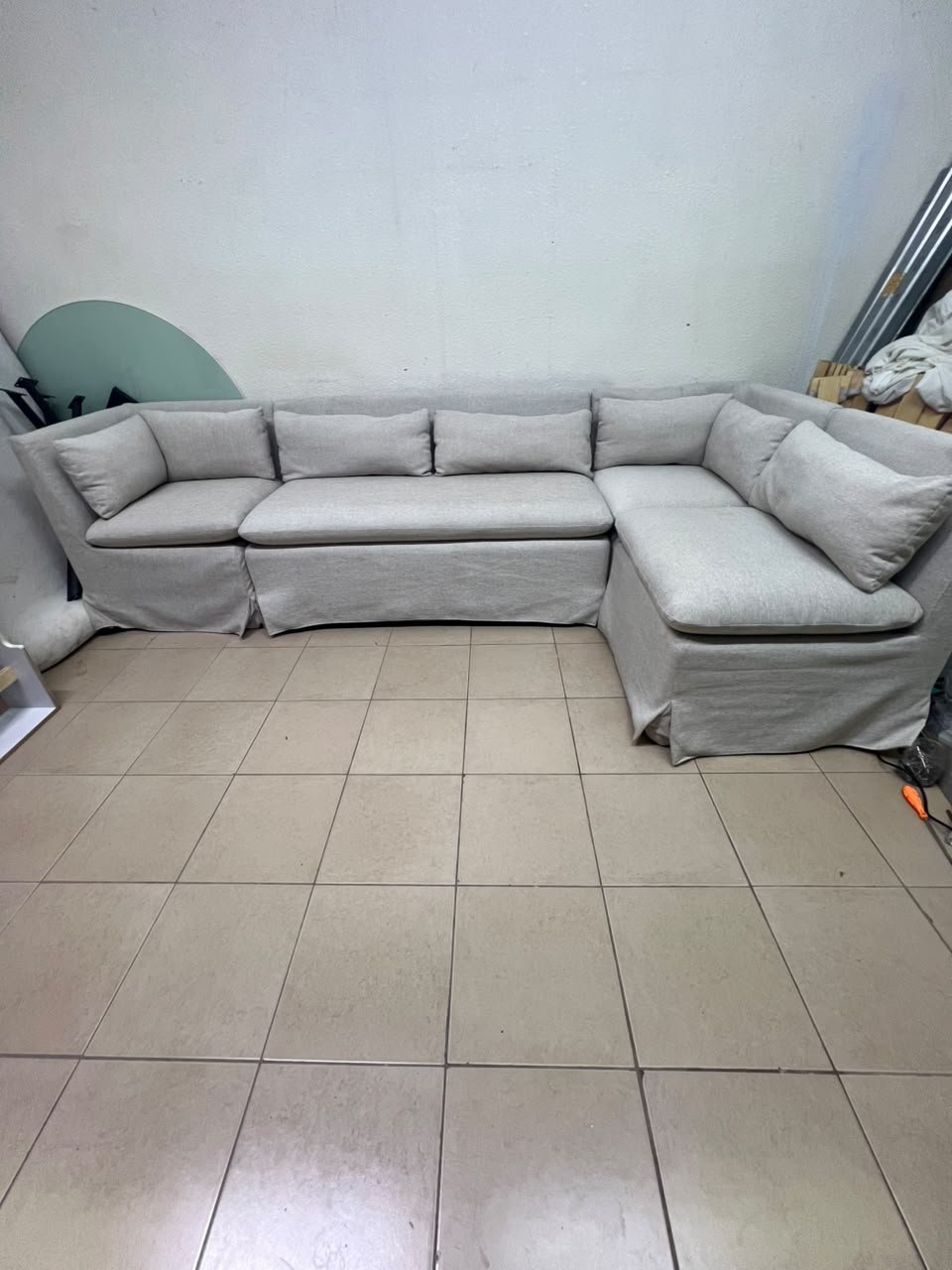 The L-shaped sectional sofa features a removable cover; it is the Crate & Barrel Belmar Modular Seating model, upholstered in a light gray, high-performance fabric with a linen-like texture, and includes comfortable back and arm cushions. - Image 11