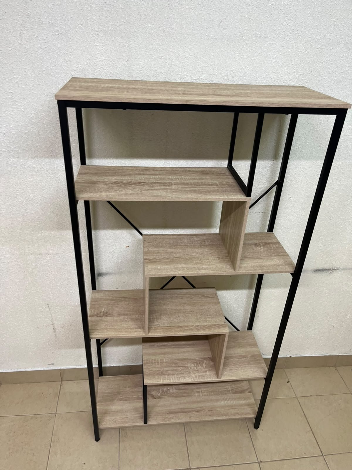 A shelving unit featuring a modern industrial design, consisting of a sturdy black metal frame and natural-look wooden shelves arranged in a tiered, graduated-width layout. - Image 7