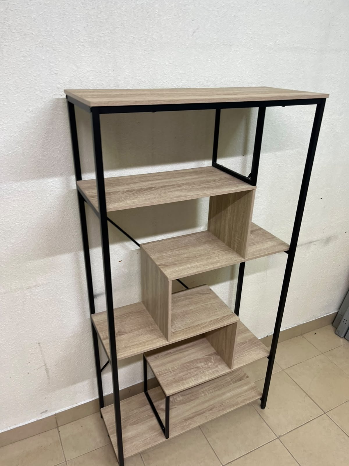 A shelving unit featuring a modern industrial design, consisting of a sturdy black metal frame and natural-look wooden shelves arranged in a tiered, graduated-width layout. - Image 8