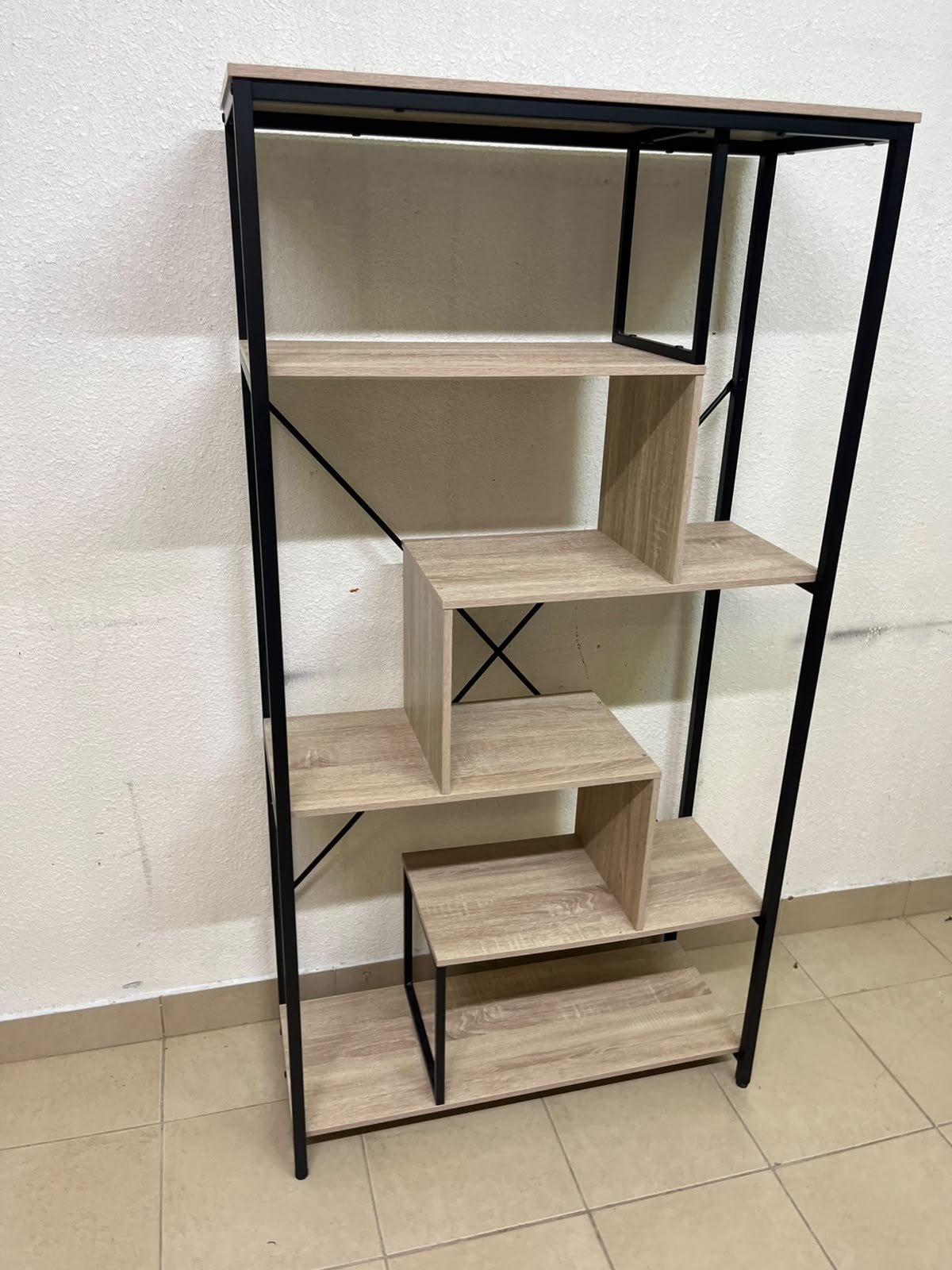 A shelving unit featuring a modern industrial design, consisting of a sturdy black metal frame and natural-look wooden shelves arranged in a tiered, graduated-width layout. - Image 10