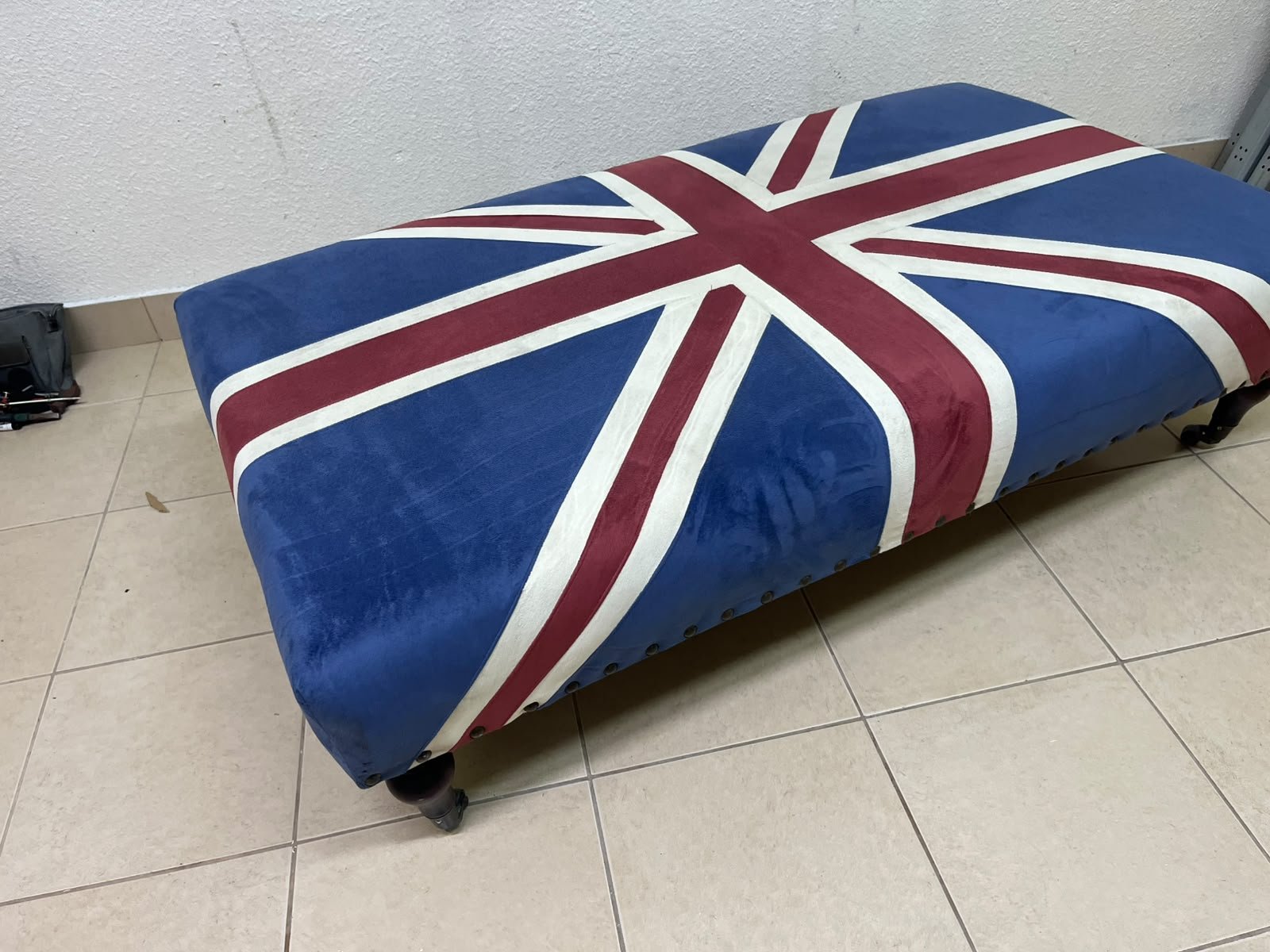 An Ottoman upholstered in luxurious velvet, featuring a vintage British flag design and metal stud detailing along the sides. - Image 10