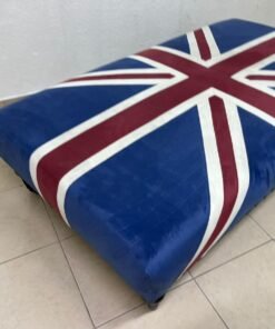 An Ottoman upholstered in luxurious velvet, featuring a vintage British flag design and metal stud detailing along the sides. - Image 4
