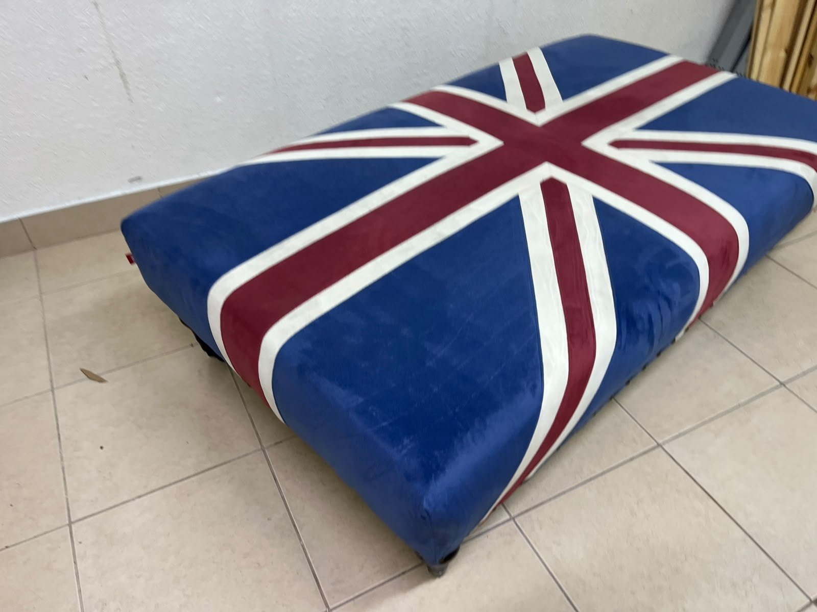 An Ottoman upholstered in luxurious velvet, featuring a vintage British flag design and metal stud detailing along the sides. - Image 4