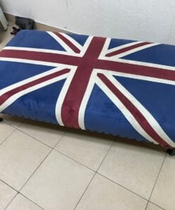 An Ottoman upholstered in luxurious velvet, featuring a vintage British flag design and metal stud detailing along the sides. - Image 6