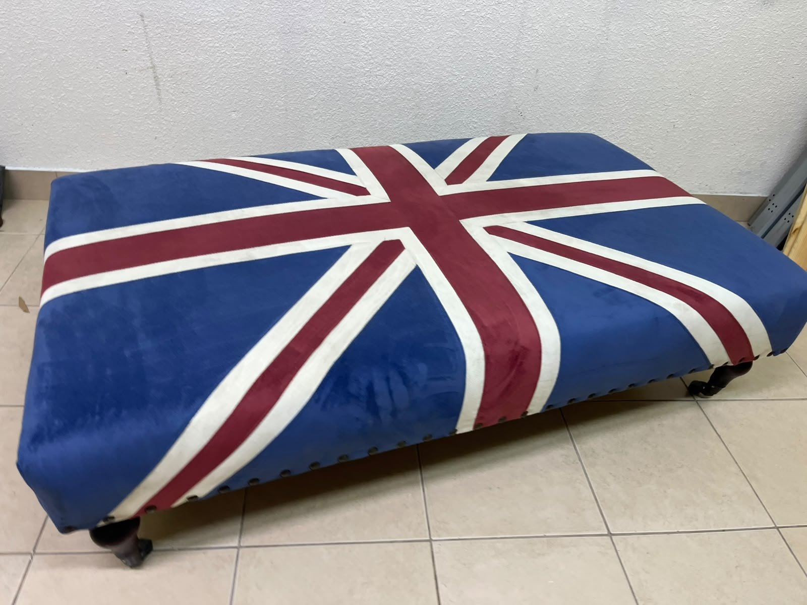 An Ottoman upholstered in luxurious velvet, featuring a vintage British flag design and metal stud detailing along the sides. - Image 7