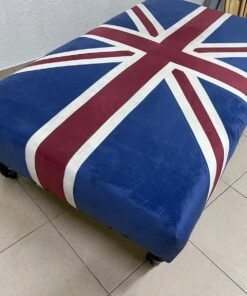 An Ottoman upholstered in luxurious velvet, featuring a vintage British flag design and metal stud detailing along the sides. - Image 9