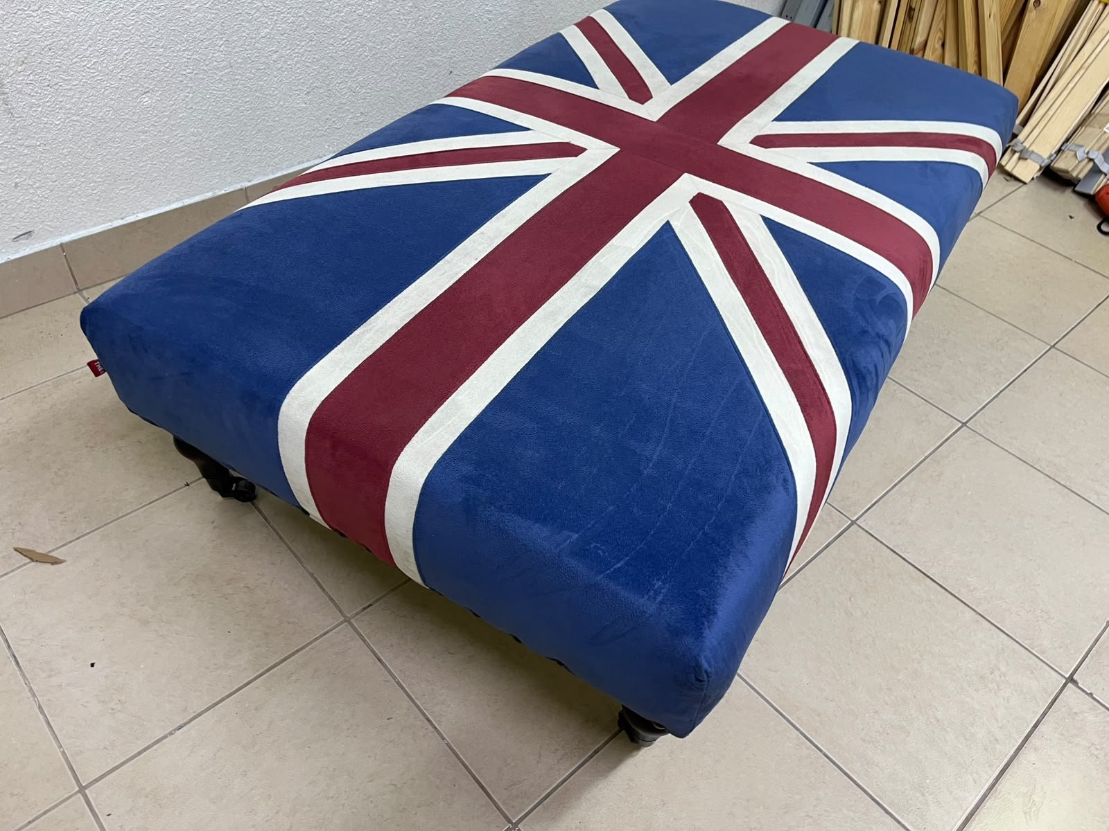 An Ottoman upholstered in luxurious velvet, featuring a vintage British flag design and metal stud detailing along the sides. - Image 9