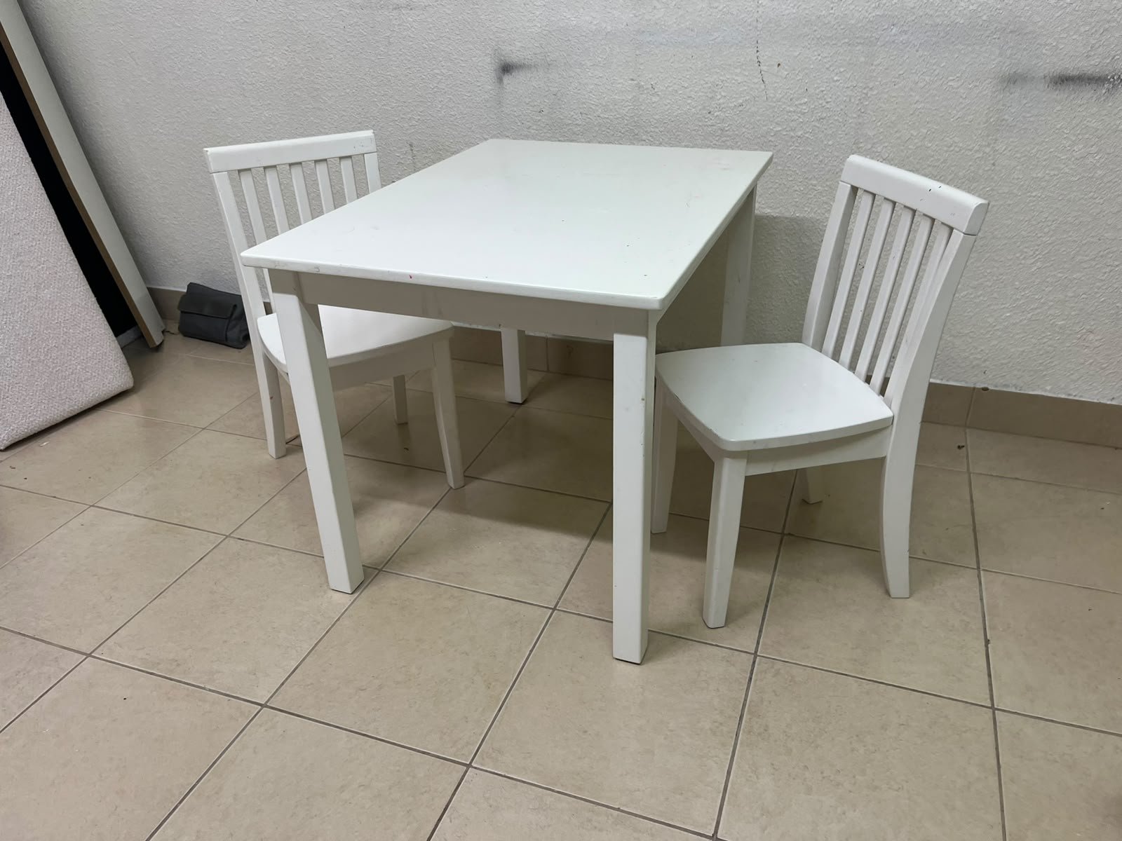 Home Centre children's table and two-chair set featuring a white wood design.