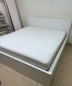 The bed is the high-frame MALM model from IKEA, featuring a white finish and practical under-bed drawers for storing bedding and clothing. - Image 9