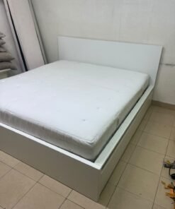 The bed is the high-frame MALM model from IKEA, featuring a white finish and practical under-bed drawers for storing bedding and clothing. - Image 10