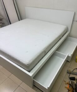 The bed is the high-frame MALM model from IKEA, featuring a white finish and practical under-bed drawers for storing bedding and clothing. - Image 11