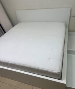 The bed is the high-frame MALM model from IKEA, featuring a white finish and practical under-bed drawers for storing bedding and clothing. - Image 12