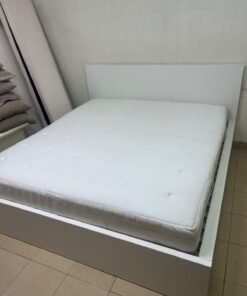 The bed is the high-frame MALM model from IKEA, featuring a white finish and practical under-bed drawers for storing bedding and clothing. - Image 13