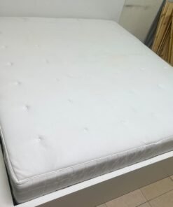 The bed is the high-frame MALM model from IKEA, featuring a white finish and practical under-bed drawers for storing bedding and clothing. - Image 14