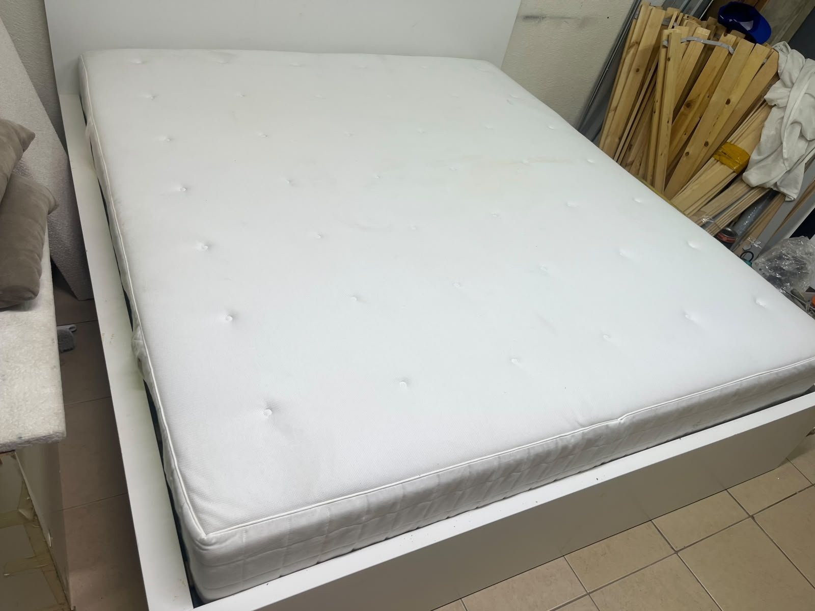 The bed is the high-frame MALM model from IKEA, featuring a white finish and practical under-bed drawers for storing bedding and clothing. - Image 14