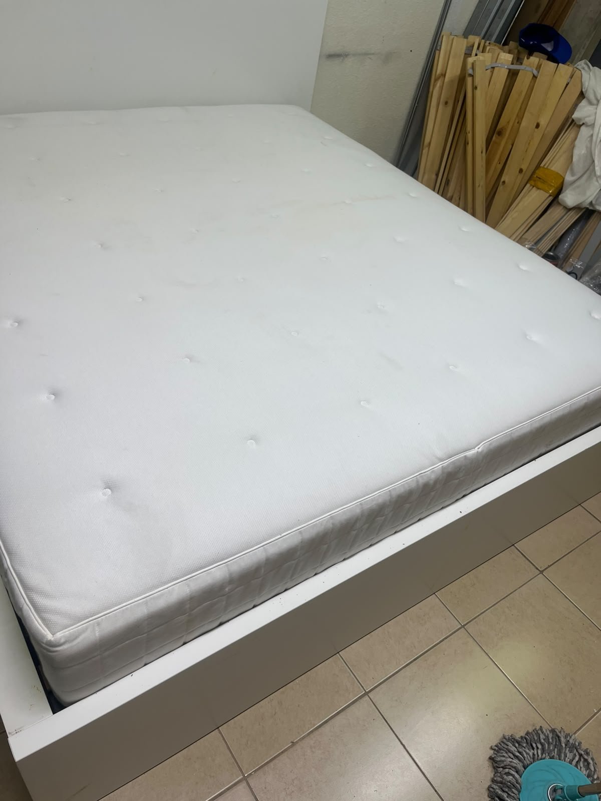 The bed is the high-frame MALM model from IKEA, featuring a white finish and practical under-bed drawers for storing bedding and clothing. - Image 15