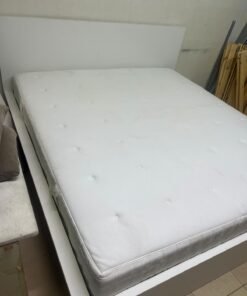 The bed is the high-frame MALM model from IKEA, featuring a white finish and practical under-bed drawers for storing bedding and clothing. - Image 6