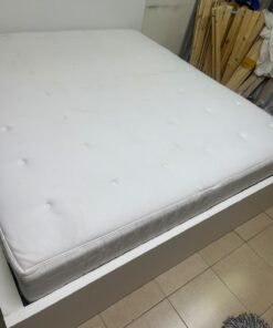 The bed is the high-frame MALM model from IKEA, featuring a white finish and practical under-bed drawers for storing bedding and clothing. - Image 8