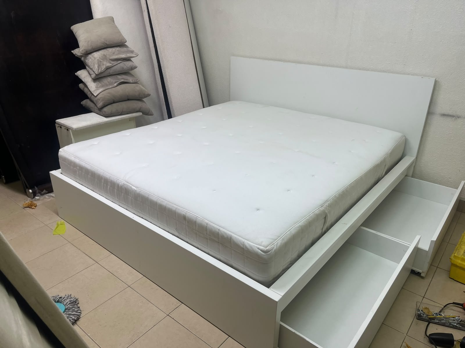 The bed is the high-frame MALM model from IKEA, featuring a white finish and practical under-bed drawers for storing bedding and clothing. - Image 7