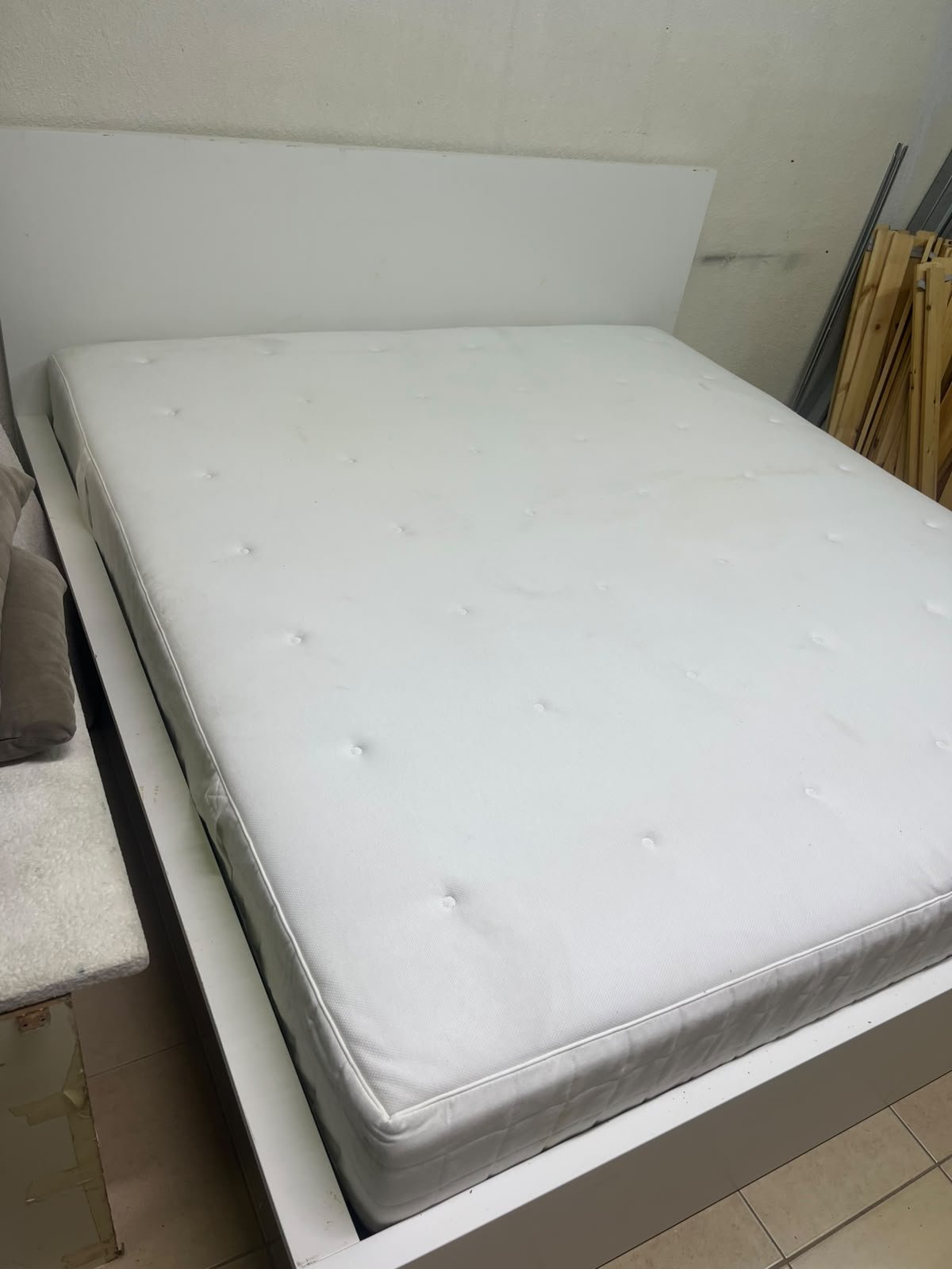 The bed is the high-frame MALM model from IKEA, featuring a white finish and practical under-bed drawers for storing bedding and clothing. - Image 6