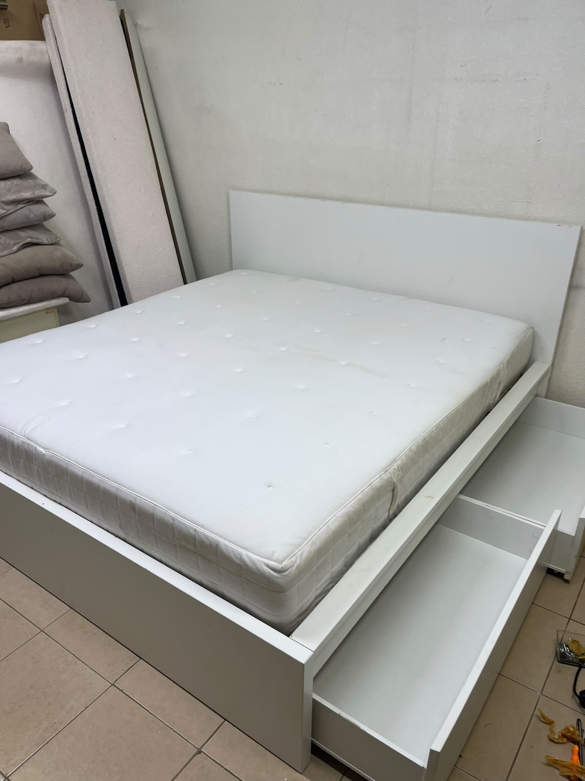 The bed is the high-frame MALM model from IKEA, featuring a white finish and practical under-bed drawers for storing bedding and clothing. - Image 4