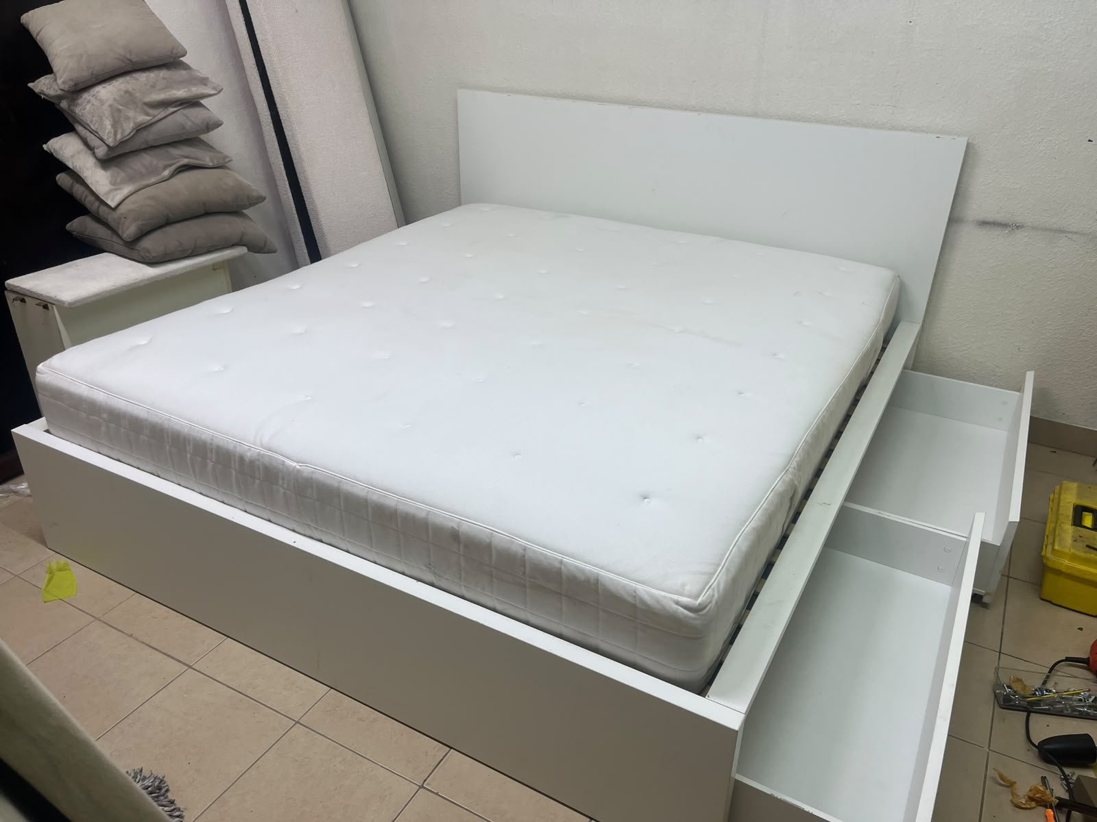 The bed is the high-frame MALM model from IKEA, featuring a white finish and practical under-bed drawers for storing bedding and clothing. - Image 3
