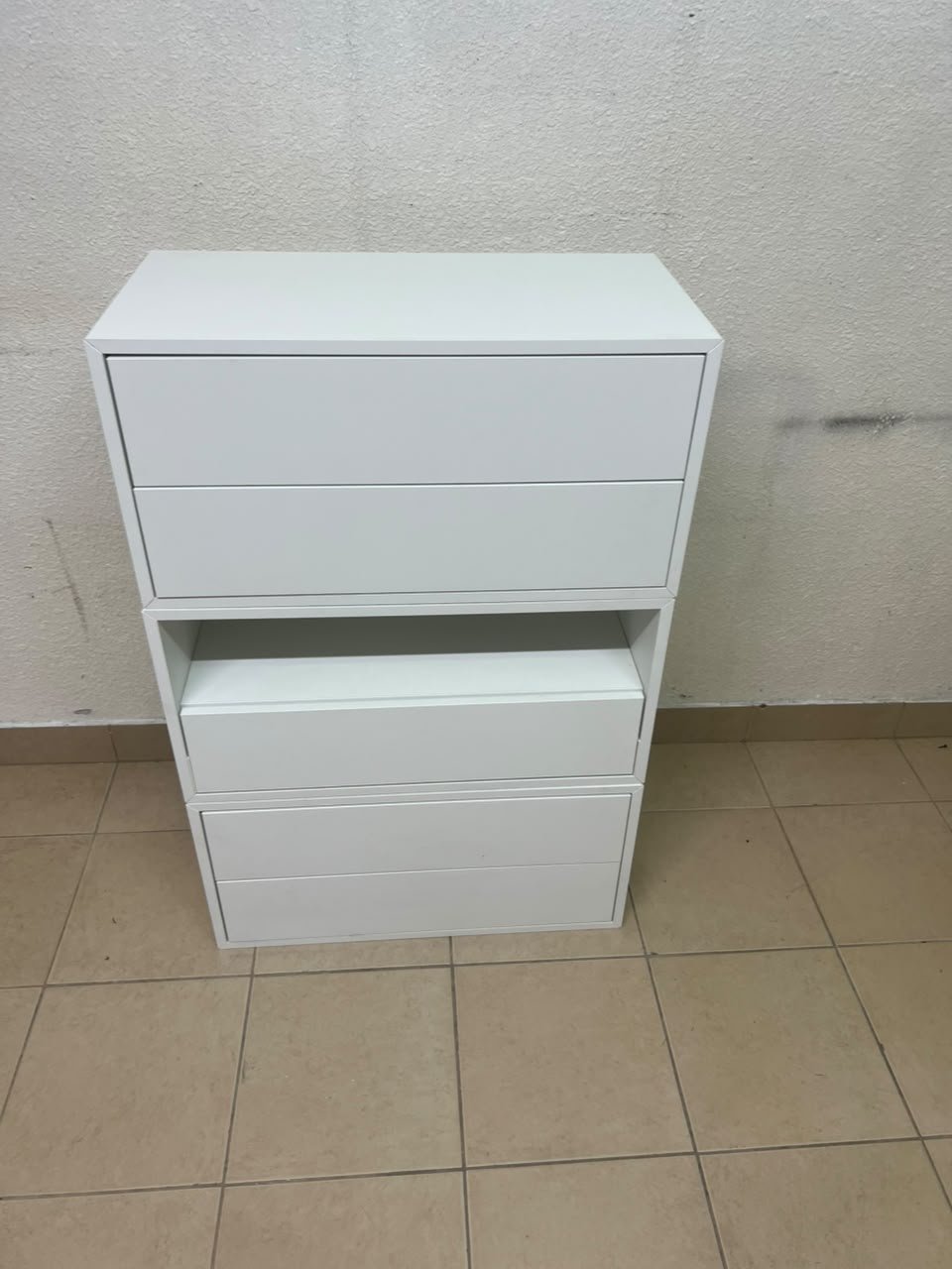 A white storage unit from IKEA’s EKET system, featuring a modular design that combines drawers with open storage space. - Image 2