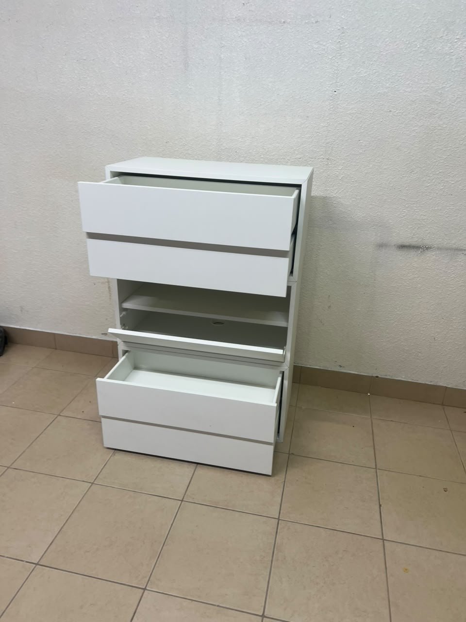 A white storage unit from IKEA’s EKET system, featuring a modular design that combines drawers with open storage space. - Image 3