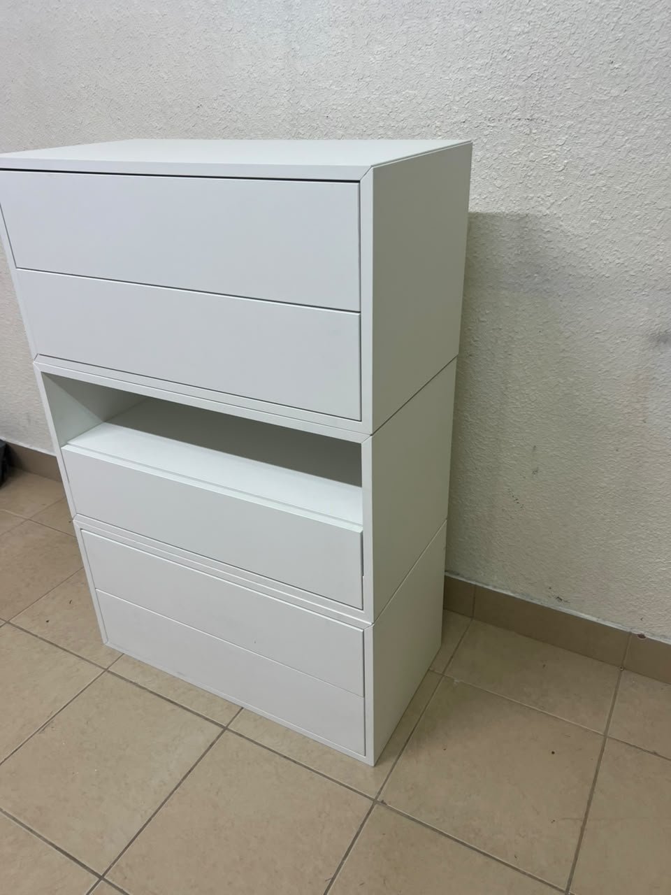 A white storage unit from IKEA’s EKET system, featuring a modular design that combines drawers with open storage space. - Image 7
