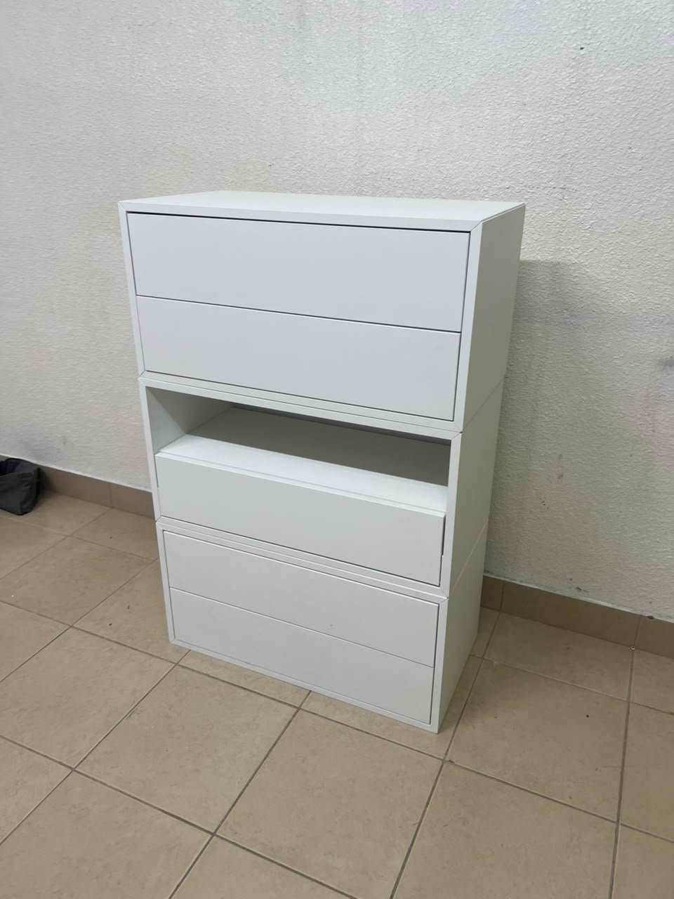 A white storage unit from IKEA’s EKET system, featuring a modular design that combines drawers with open storage space. - Image 6