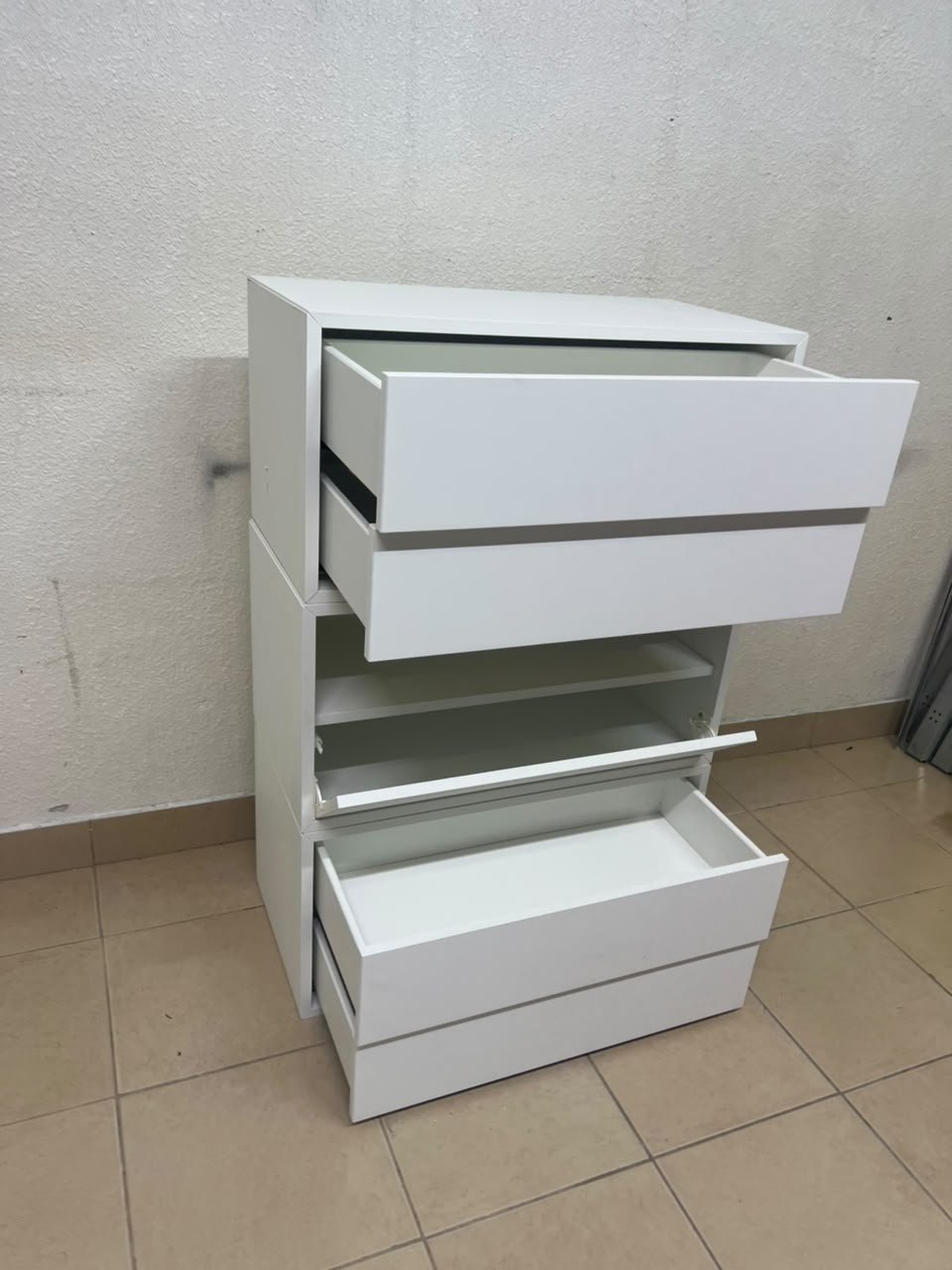 A white storage unit from IKEA’s EKET system, featuring a modular design that combines drawers with open storage space. - Image 5