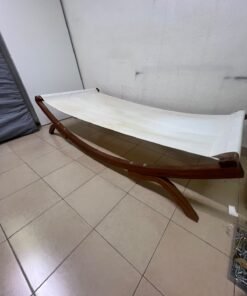 An elegantly designed, curved wooden hammock bed featuring comfortable white fabric for relaxation.