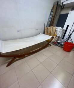 An elegantly designed, curved wooden hammock bed featuring comfortable white fabric for relaxation. - Image 4