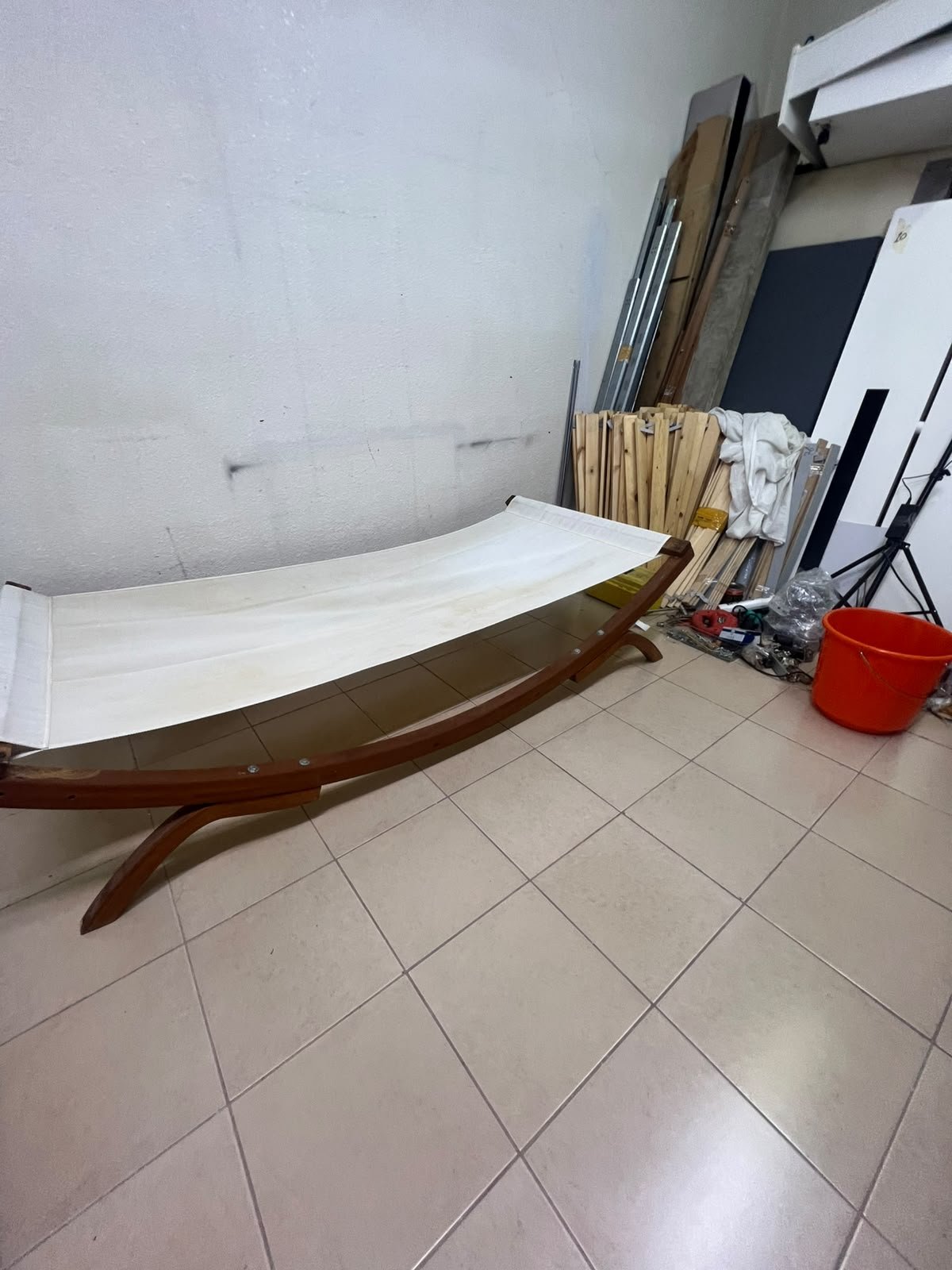 An elegantly designed, curved wooden hammock bed featuring comfortable white fabric for relaxation. - Image 4