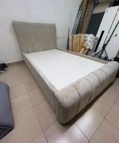 An elegantly designed, modern upholstered bed featuring a high headboard padded with prominent vertical lines and a curved footboard. - Image 4