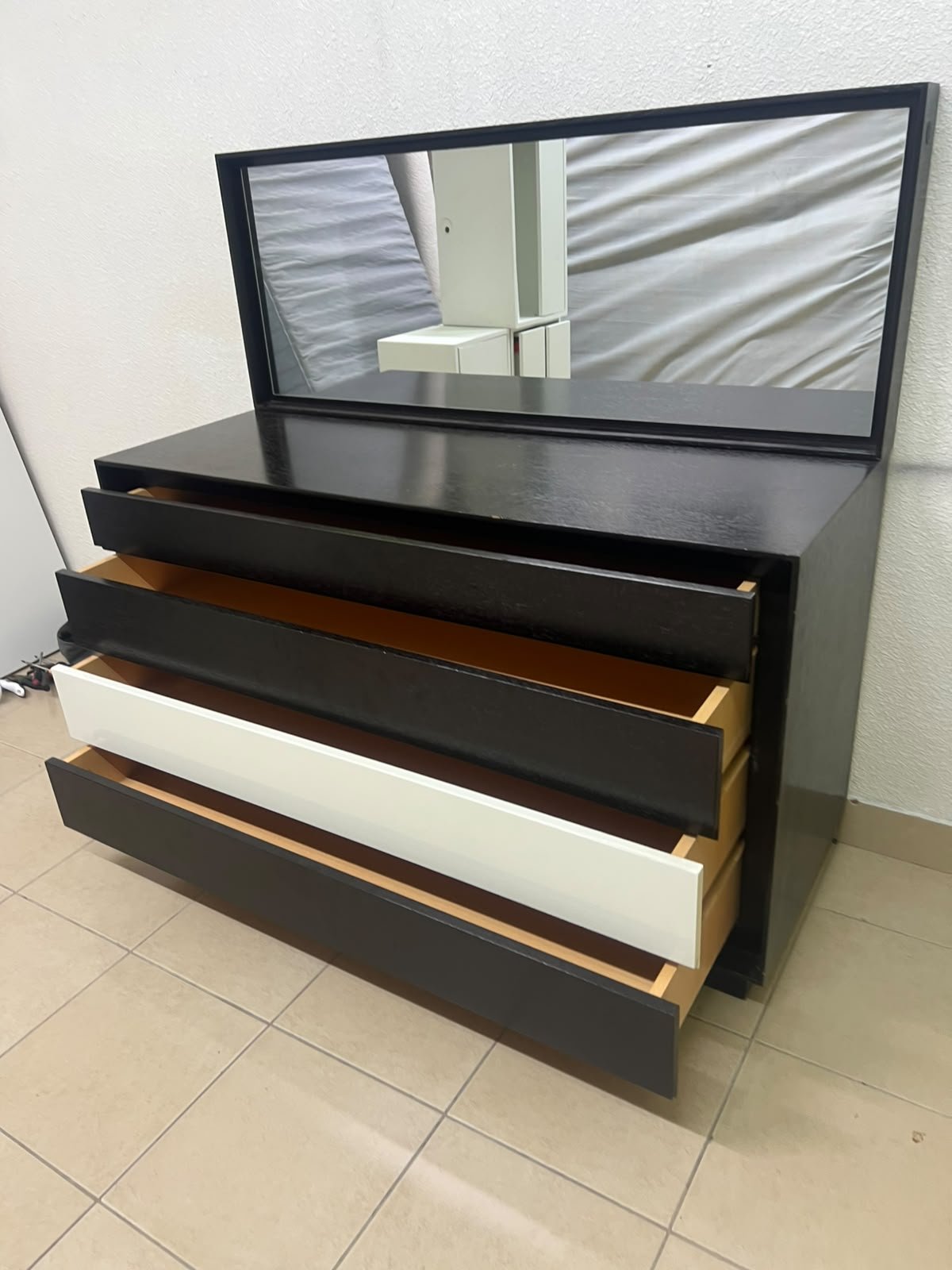 A dark brown wooden dresser featuring a wide white central drawer, accompanied by a large mirror with a matching rectangular frame. - Image 3